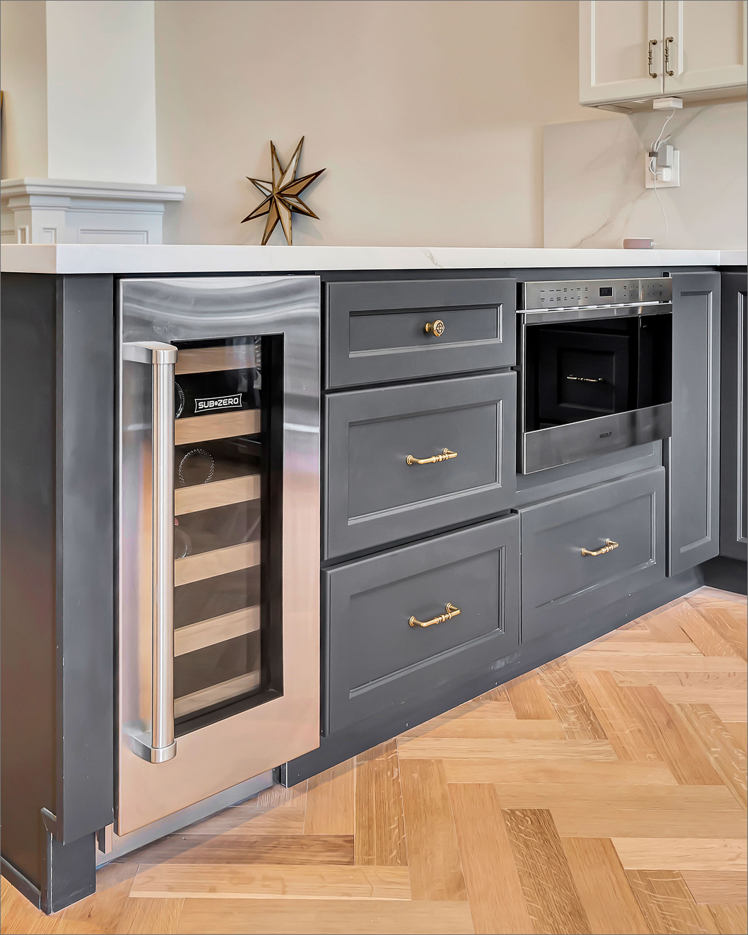 Charcoal kitchen cabinetry with brass hardware