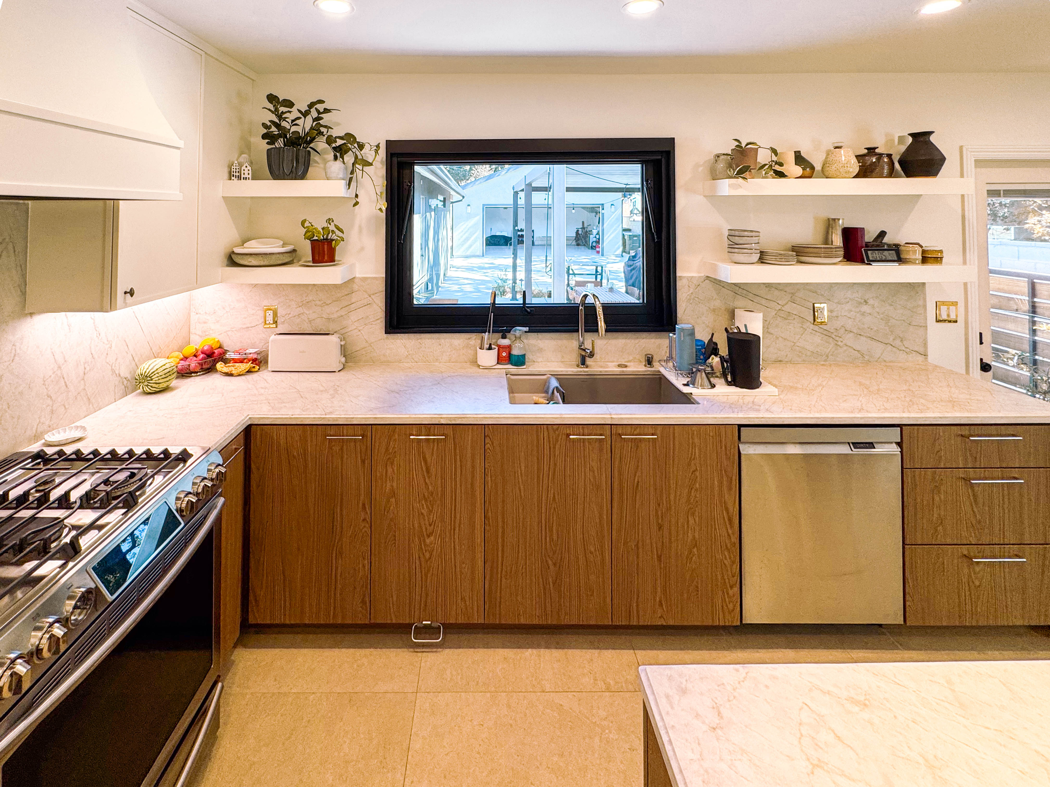 Kitchen remodel with walnut cabinets and quartzite counters