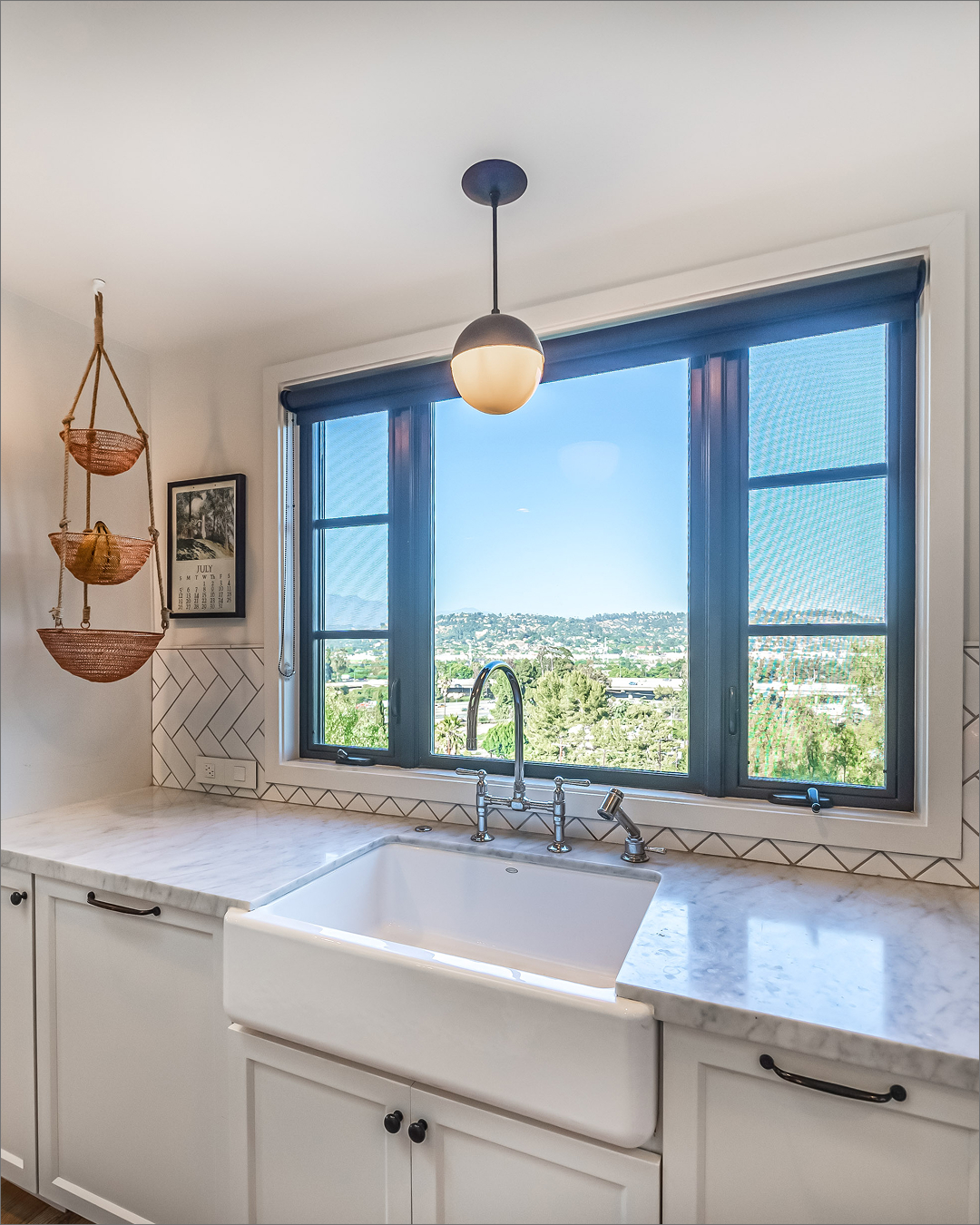 Farmhouse sink under a view window
